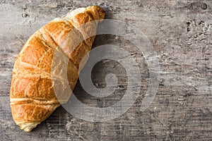 Croissant on wooden table. Copyspace photo