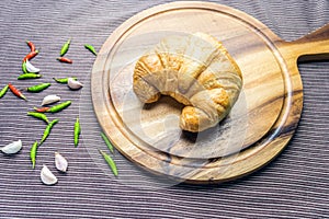 Croissant on woonden plate