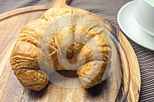 Croissant on woonden plate