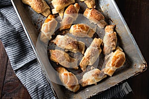 Croissants with chocolate on baking tray