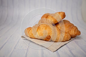 Croissants with coffee cups with flour and eggs on a white background, breakfast, brown bread, morning drinks, fantasy world: