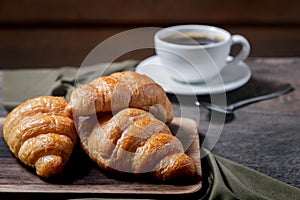 Croissants and coffee on the table in the morning
