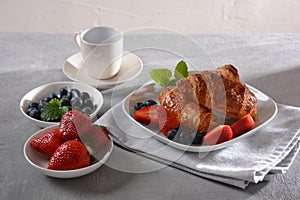 Croissants, fresh and dried fruits, fresh juice