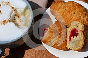 Croissants with jam and cappuccino for breakfast