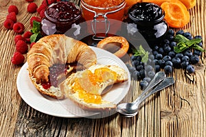 croissants with marmalade and assortment of jams, seasonal berries, apricot, mint and fruits