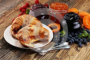 croissants with marmalade and assortment of jams, seasonal berries, apricot, mint and fruits