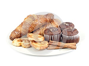 Croissants, muffins, cookies and stiks cinnamon of plate photo