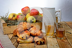 Croissants and pains au chocolat with a box of apples