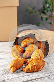 Croissants in a paper bag. Food delivery online order.