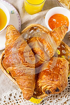 Croissants pastry for breakfast with tea and orange juice