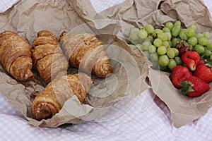 Croissants strawberries and grapes on a picnic