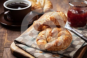 Croissants with strawberry jam and coffee