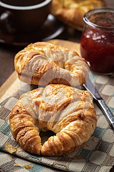 Croissants with strawberry jam and coffee