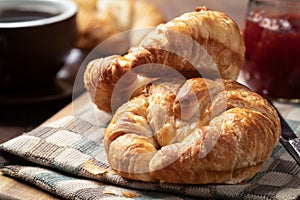 Croissants with strawberry jam and coffee