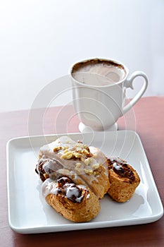 Croissants in a white plate and coffee