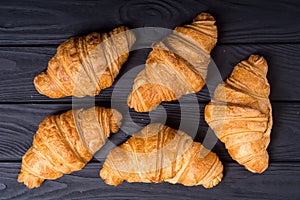 Croissants on wooden background