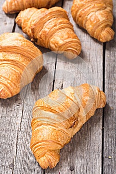 Croissants on wooden background