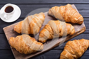 Croissants on wooden background