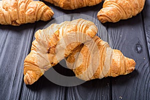 Croissants on wooden background