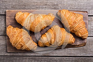 Croissants on wooden background