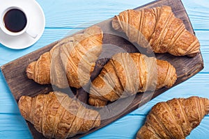 Croissants on wooden background
