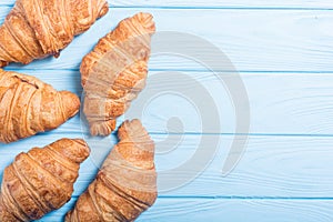 Croissants on wooden background