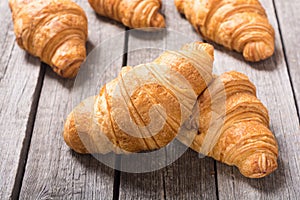 Croissants on wooden background