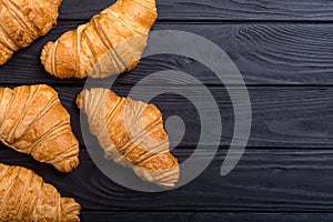 Croissants on wooden background