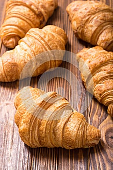 Croissants on wooden background