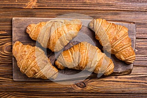 Croissants on wooden background