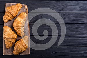 Croissants on wooden background