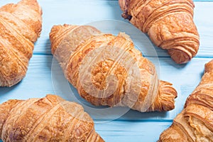 Croissants on wooden background