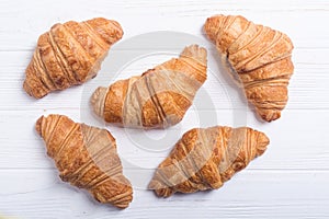 Croissants on wooden background