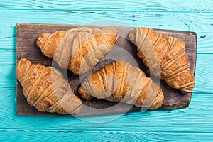 Croissants on wooden background