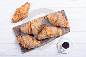 Croissants on wooden background