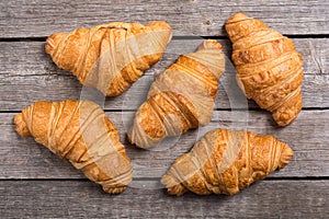 Croissants on wooden background