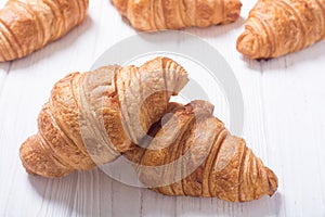 Croissants on wooden background