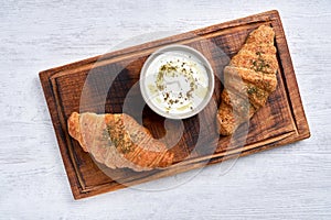 Croissants with zaatar  and labneh  on wooden board. Top view
