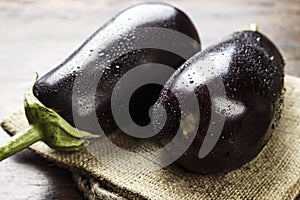 A crop of aubergines on a table