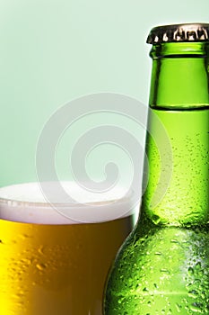 Crop of bottle and glass of beer