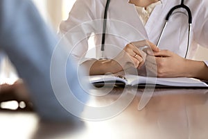 Close up of female doctor have consultation with patient photo