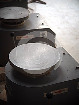 Crop closeup on small rotate plate machine for ceramic production in a demonstrate factory