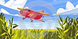 Crop duster plane flying over green corn field