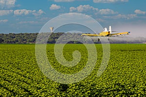 Crop Duster Plane Flying Over Green Fields