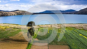 Crop fields in the Peruvian Andes Paca lake in Junin