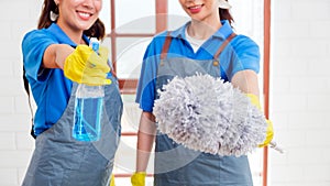 Crop image of Asian young cleaning service women worker team working in the house. Girls housekeeper cleaner, hold feather duster