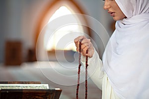 Crop Muslim woman with string of beads