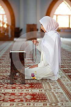 Crop Muslim woman with string of beads