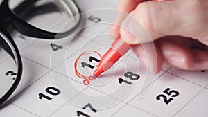 Crop person encircling deadline date in calendar