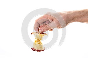 Crop person throwing away core of fresh apple